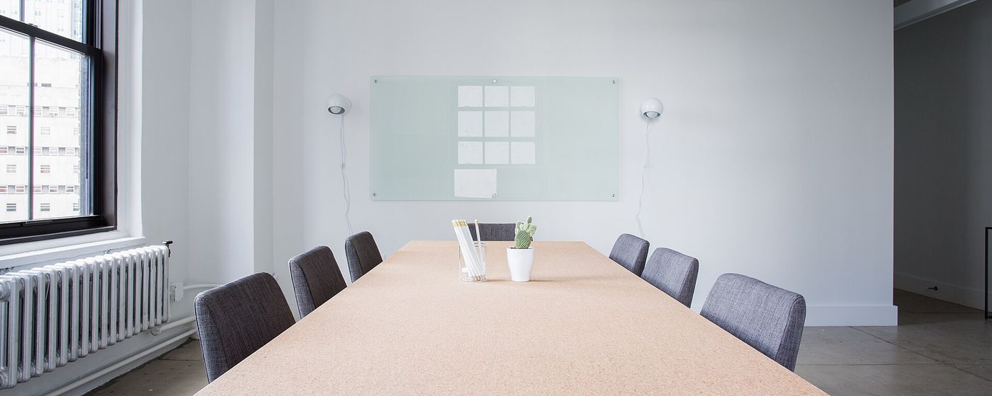 An empty boardroom table ready for a meeting